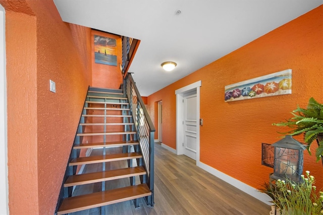 staircase featuring hardwood / wood-style floors