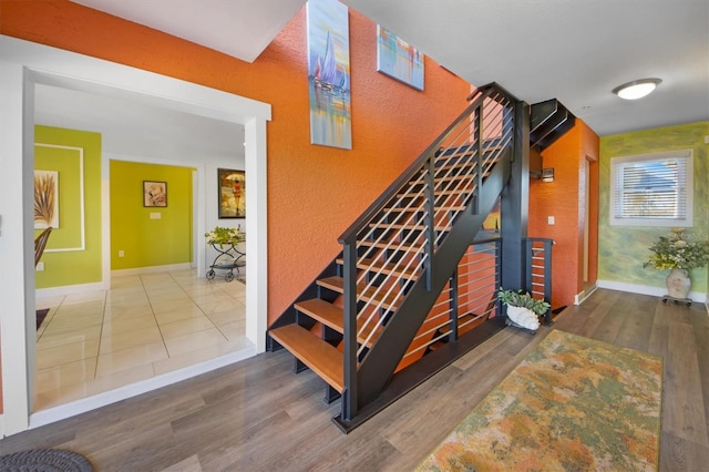 staircase featuring hardwood / wood-style flooring