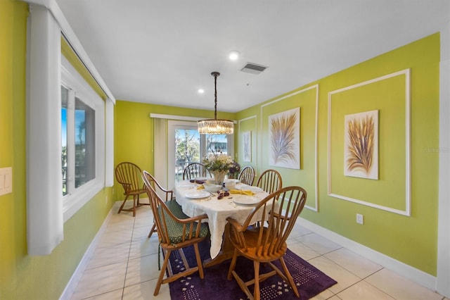 tiled dining area with a notable chandelier