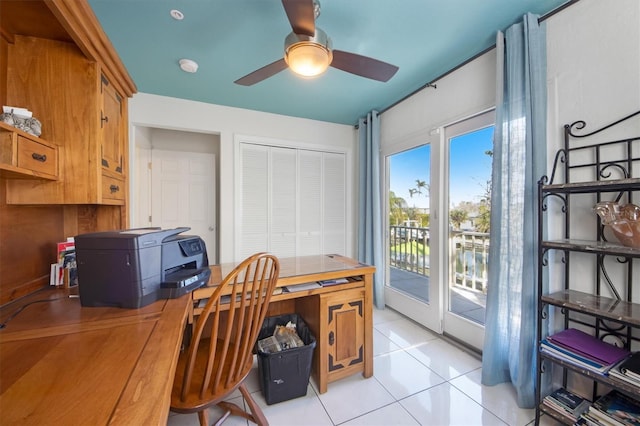 office featuring light tile patterned floors and ceiling fan