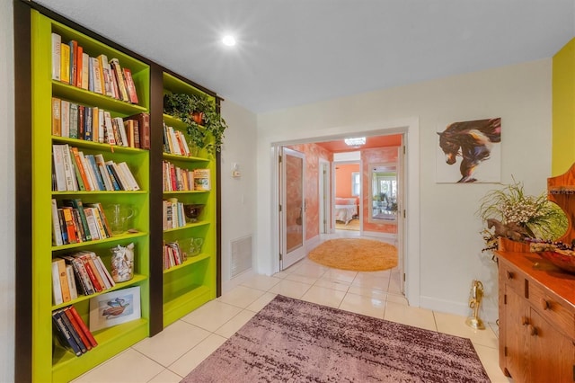 corridor featuring light tile patterned floors