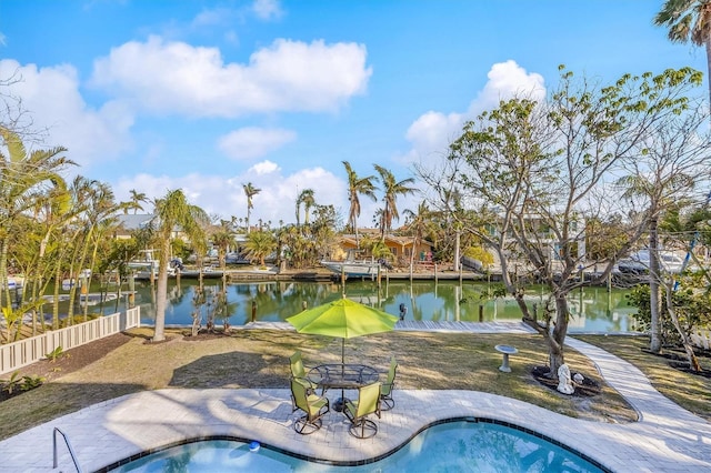 view of swimming pool with a water view and a hot tub