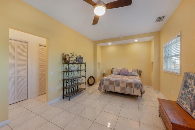 tiled bedroom featuring ceiling fan