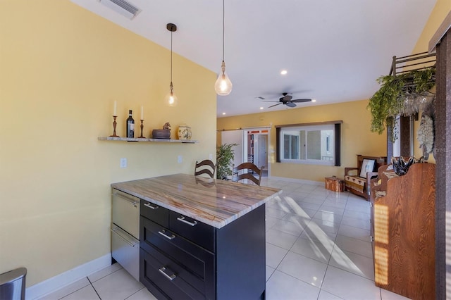 kitchen with ceiling fan, decorative light fixtures, kitchen peninsula, and light tile patterned floors