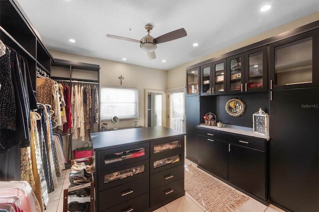 spacious closet featuring light tile patterned floors and ceiling fan