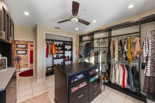 spacious closet featuring light tile patterned floors and ceiling fan