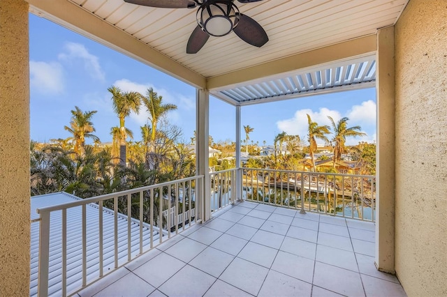 balcony with a water view and ceiling fan