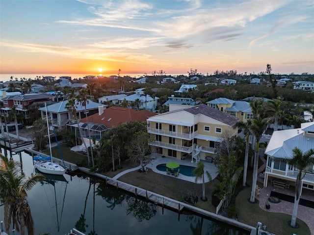 aerial view at dusk with a water view