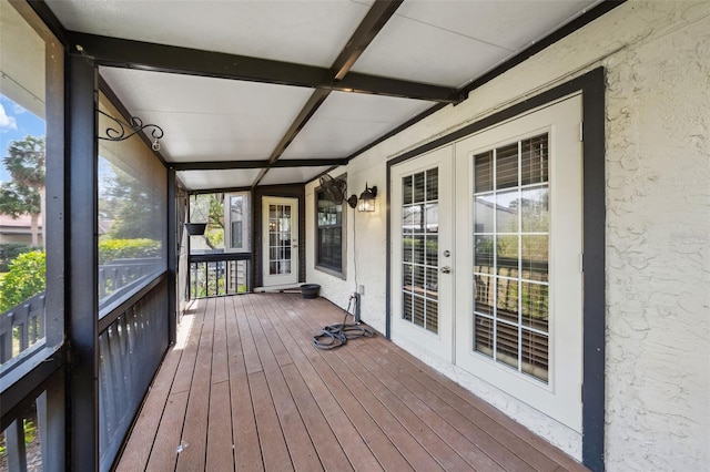 unfurnished sunroom with beamed ceiling and french doors