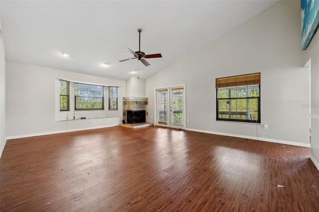 unfurnished living room featuring high vaulted ceiling, dark hardwood / wood-style floors, and ceiling fan