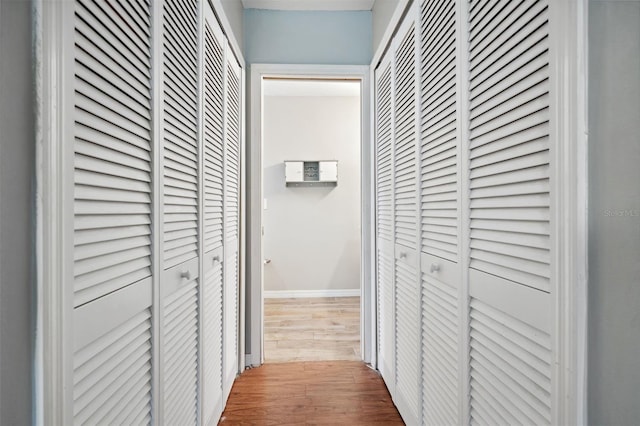 corridor with hardwood / wood-style floors