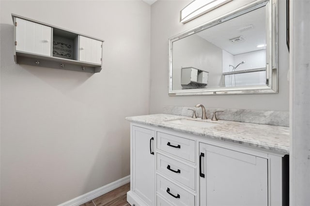 bathroom with vanity and wood-type flooring