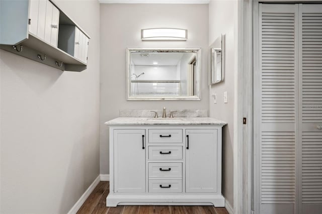 bathroom with vanity, wood-type flooring, and a shower with door