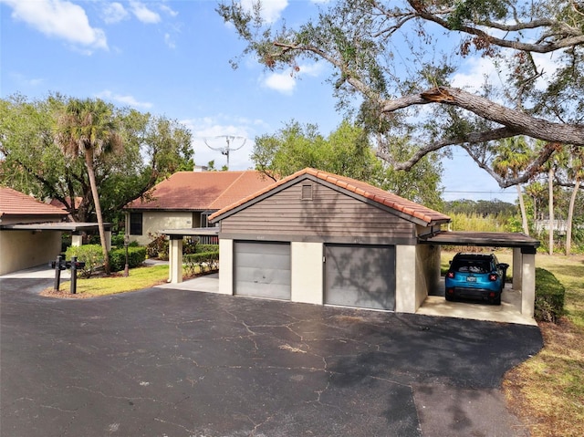 view of front of house featuring a garage and a carport