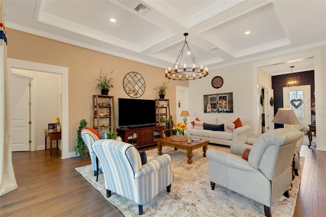 living room with an inviting chandelier, coffered ceiling, hardwood / wood-style floors, and crown molding