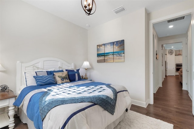 bedroom with dark hardwood / wood-style flooring