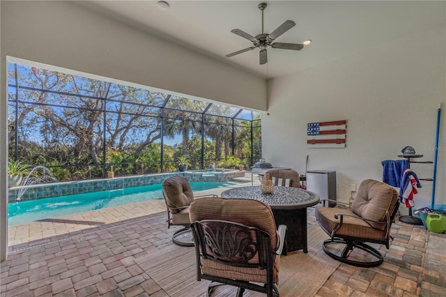 view of patio / terrace featuring pool water feature, a lanai, and ceiling fan