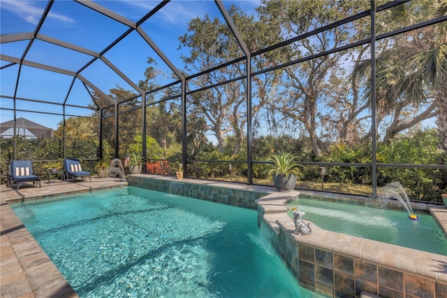 view of pool with an in ground hot tub, pool water feature, a patio area, and a lanai