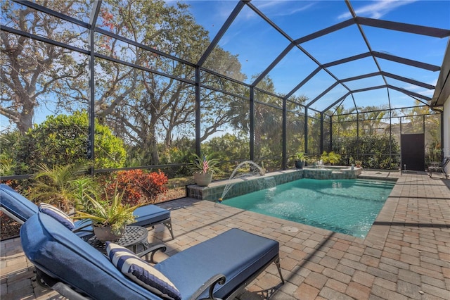 view of pool with a lanai, a patio, and pool water feature