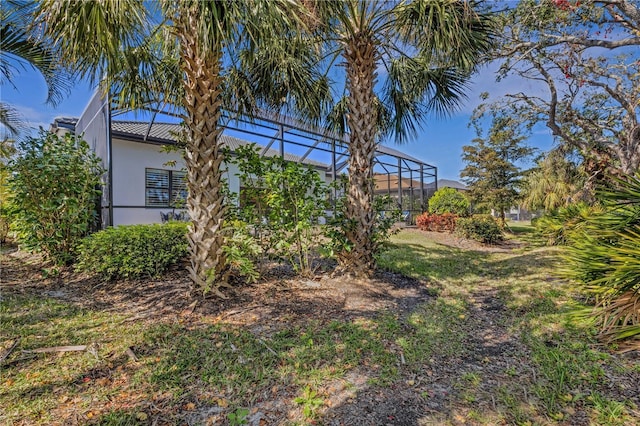 view of yard featuring glass enclosure