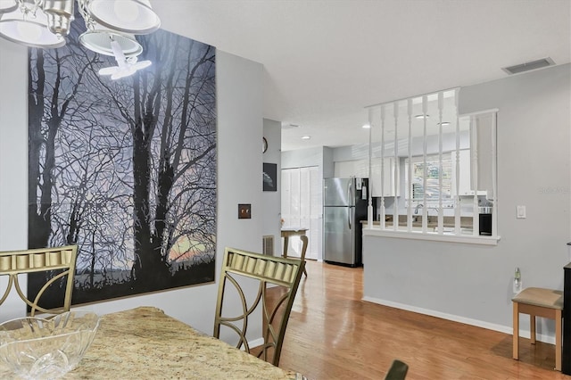 dining area featuring a chandelier and light hardwood / wood-style floors