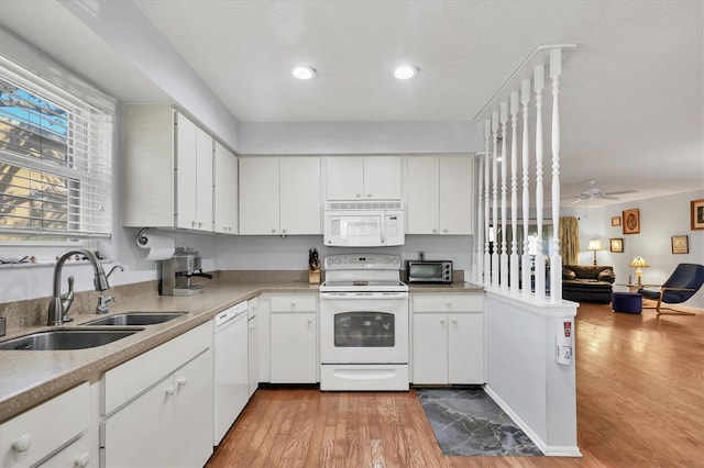 kitchen with sink, white cabinets, ceiling fan, white appliances, and light hardwood / wood-style flooring