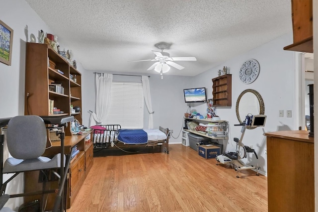 office with ceiling fan, light hardwood / wood-style flooring, and a textured ceiling