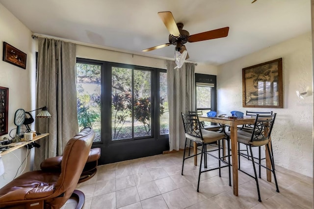 dining space featuring light tile patterned floors and ceiling fan