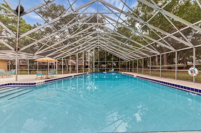 view of pool featuring a patio and glass enclosure