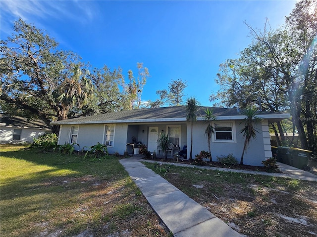 single story home featuring a front yard