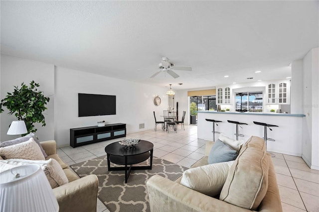 living room featuring ceiling fan and light tile patterned floors