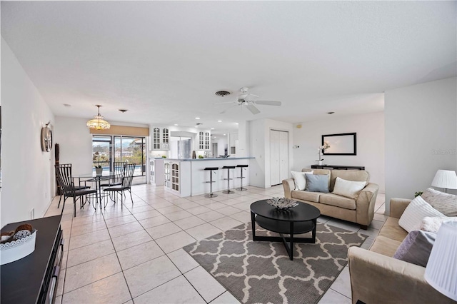 living room featuring ceiling fan and light tile patterned flooring