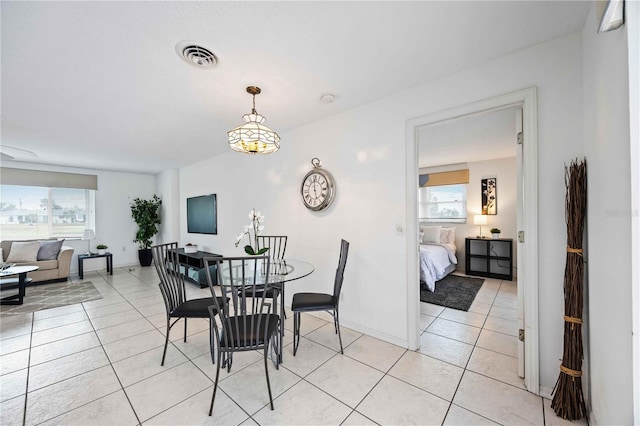 tiled dining room with a wealth of natural light