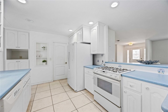 kitchen featuring white cabinetry, light tile patterned floors, built in features, and white appliances