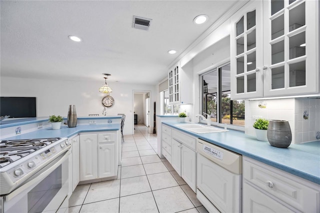 kitchen with light tile patterned floors, white appliances, white cabinetry, decorative backsplash, and decorative light fixtures