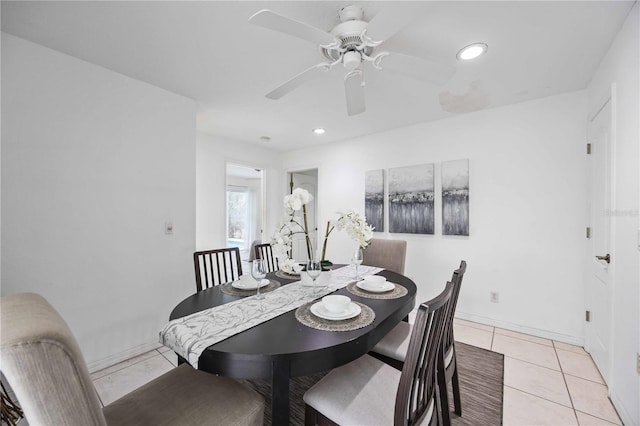 tiled dining area with ceiling fan