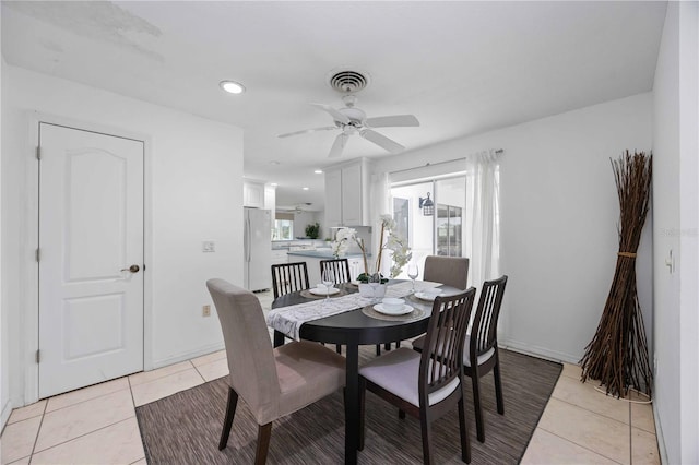 tiled dining room featuring ceiling fan