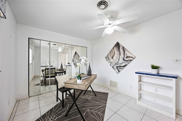 tiled home office with ceiling fan