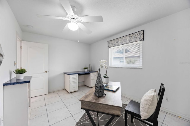 tiled office with ceiling fan and a textured ceiling