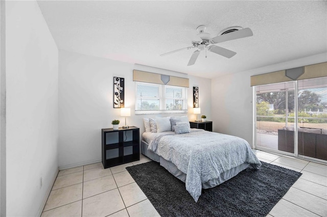 bedroom with ceiling fan, access to exterior, multiple windows, and light tile patterned floors