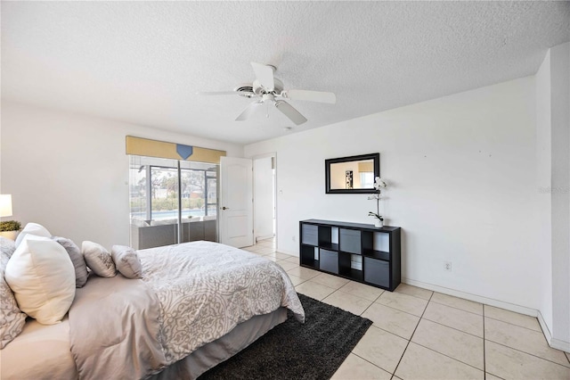 tiled bedroom featuring a textured ceiling and ceiling fan