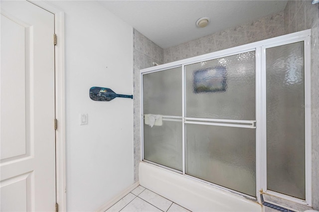 bathroom featuring enclosed tub / shower combo and tile patterned flooring