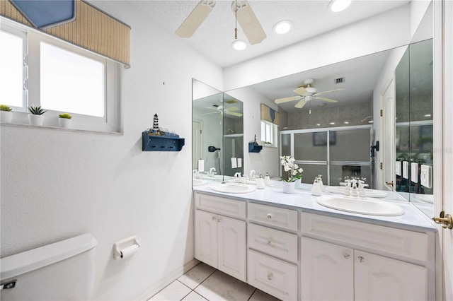 bathroom with vanity, an enclosed shower, toilet, tile patterned floors, and a textured ceiling