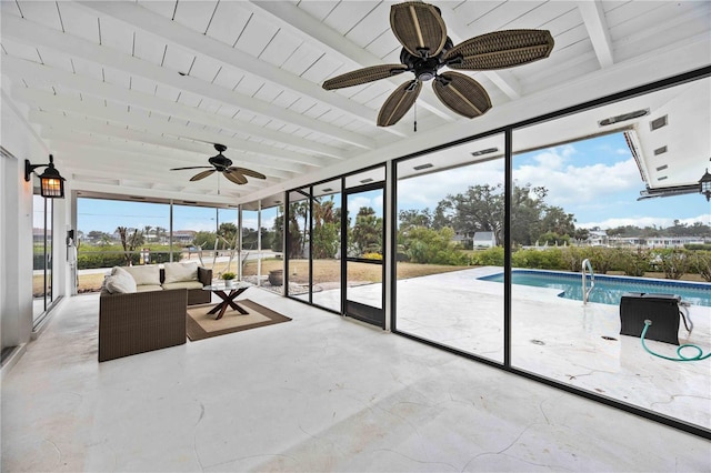 sunroom featuring plenty of natural light and beamed ceiling