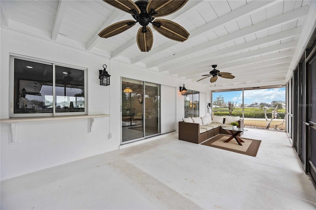 unfurnished sunroom featuring beamed ceiling