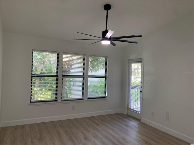 spare room with hardwood / wood-style flooring and ceiling fan