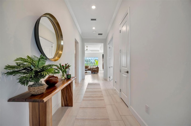 hall featuring ornamental molding and light tile patterned flooring