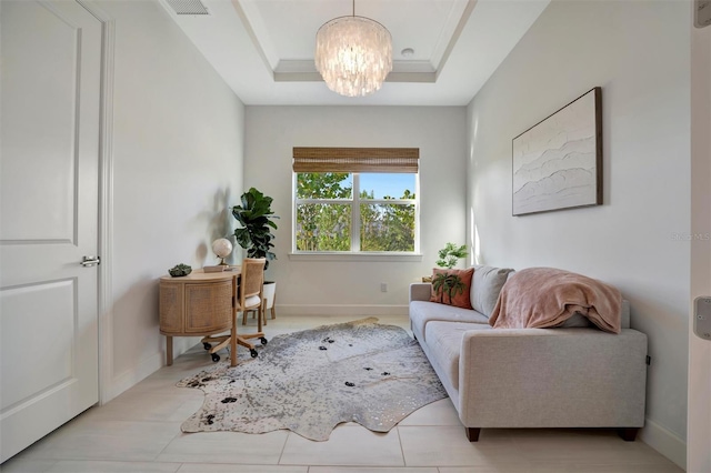 interior space with an inviting chandelier and a raised ceiling