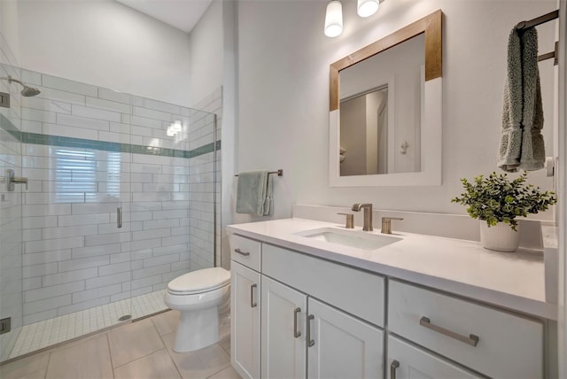 bathroom featuring vanity, an enclosed shower, tile patterned flooring, and toilet