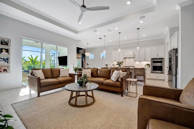 living room featuring crown molding, light tile patterned floors, ceiling fan, and a tray ceiling